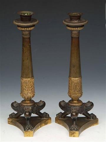 Appraisal: A PAIR OF EMPIRE BRASS CANDLESTICKS of tapering italianate triform