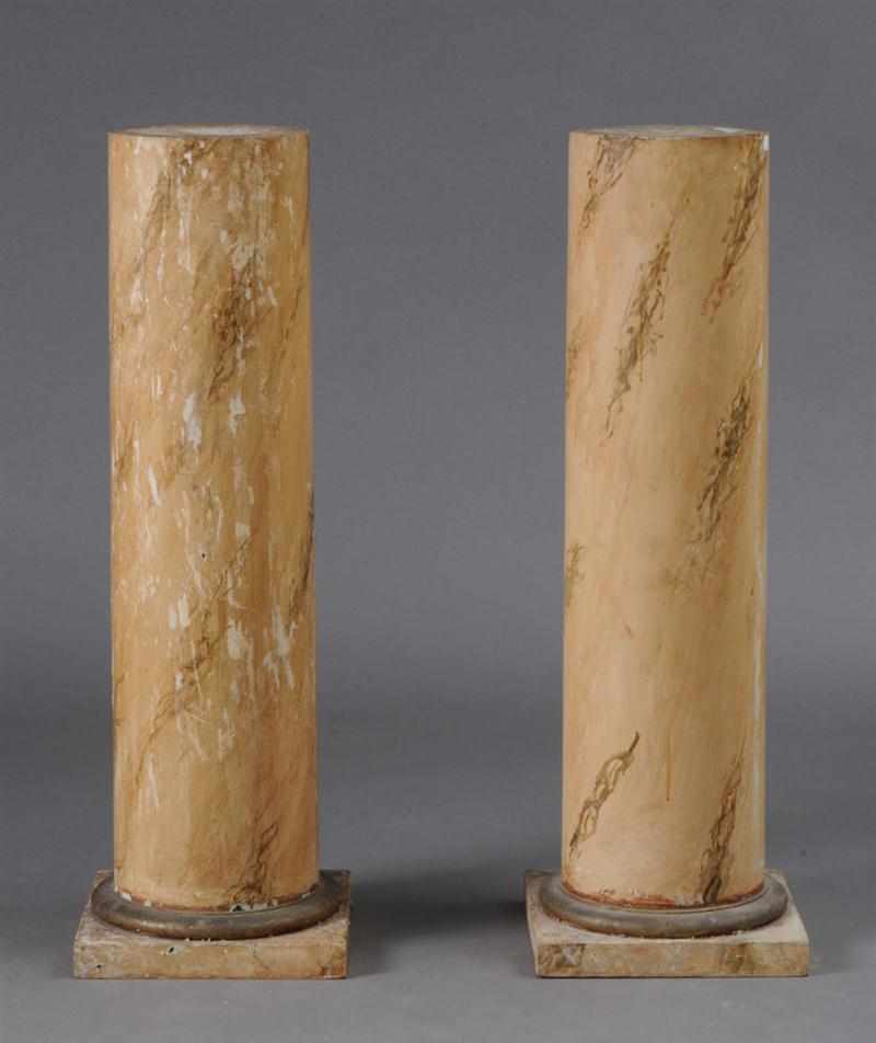 Appraisal: PAIR OF CONTINENTAL MARBELIZED WOOD PEDESTALS The circular shafts on