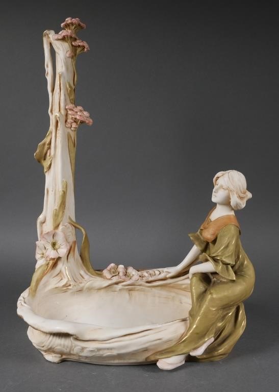 Appraisal: Large porcelain sculpture featuring a woman sitting on side of