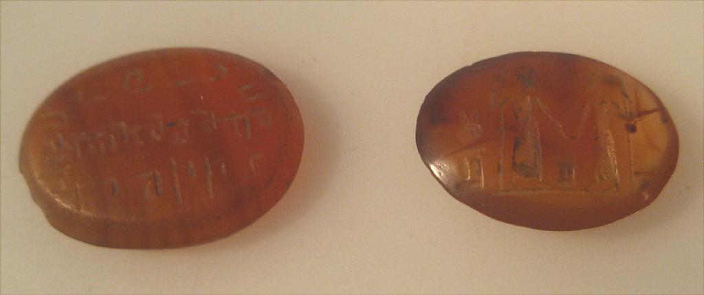 Appraisal: Two carnelian engraved intaglios the first with two figures holding