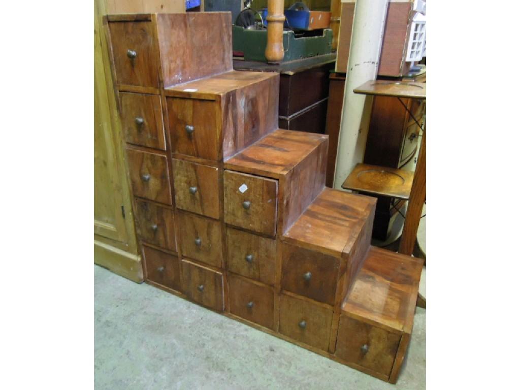 Appraisal: A hardwood nest of fifteen small drawers within a stepped