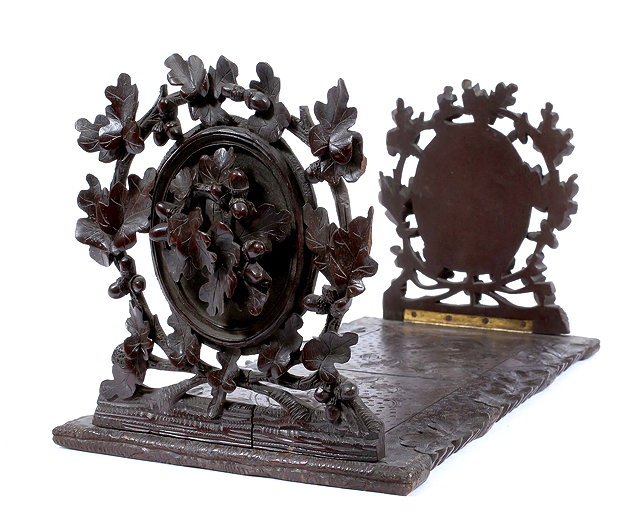 Appraisal: A TH CENTURY CARVED BLACK FOREST BOOKSTAND decorated with oak