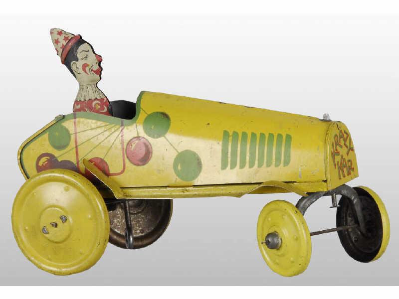 Appraisal: Strauss Tin Wind-Up Clown in Toy Auto Description Toy has