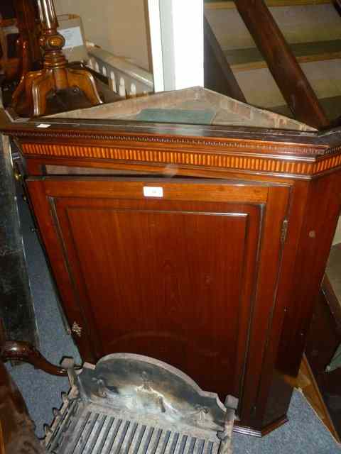 Appraisal: A GEORGIAN MAHOGANY CORNER CUPBOARD enclosed by a single panel