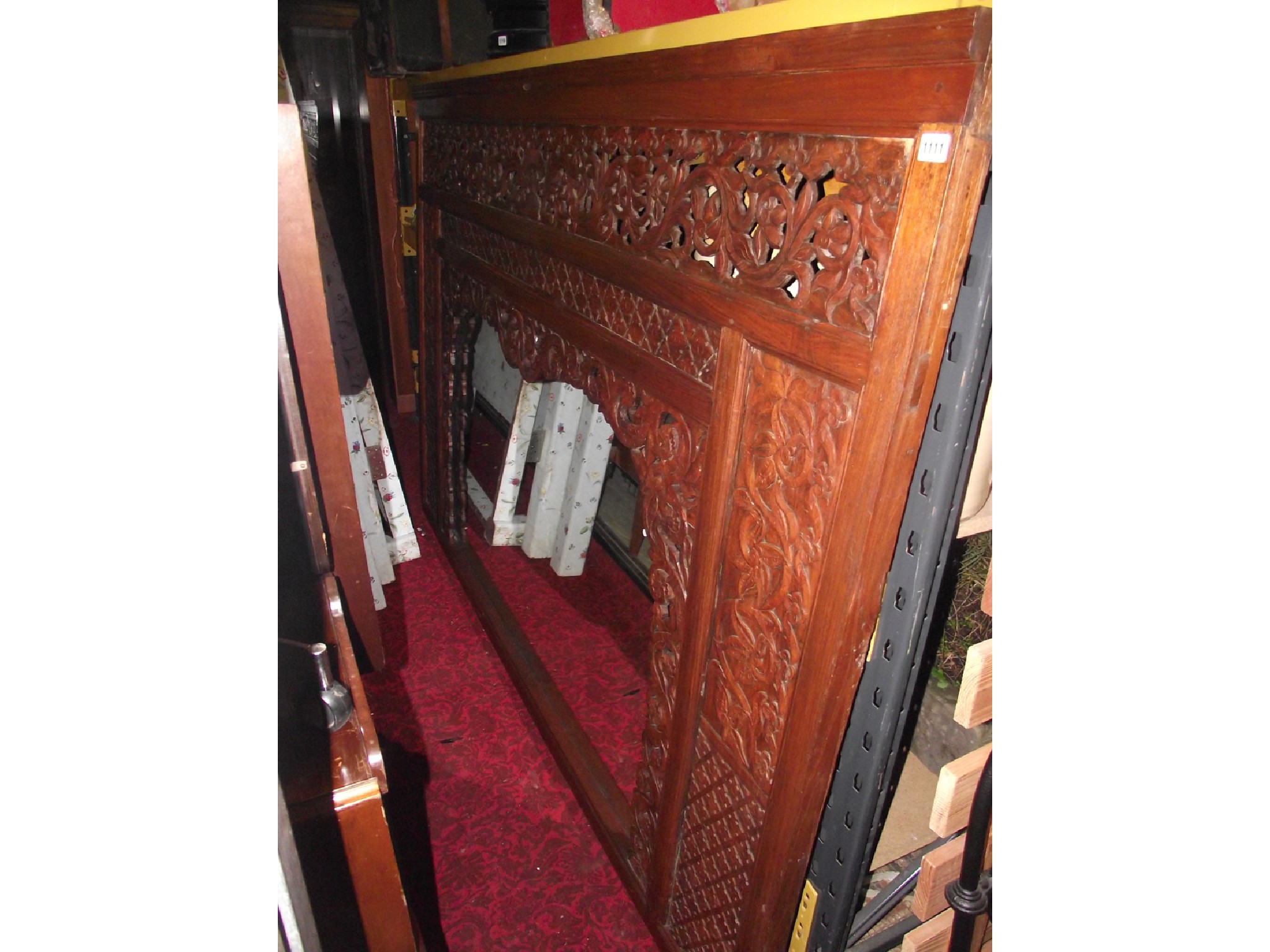 Appraisal: A substantial Eastern hardwood framed overmantle mirror with profusely carved