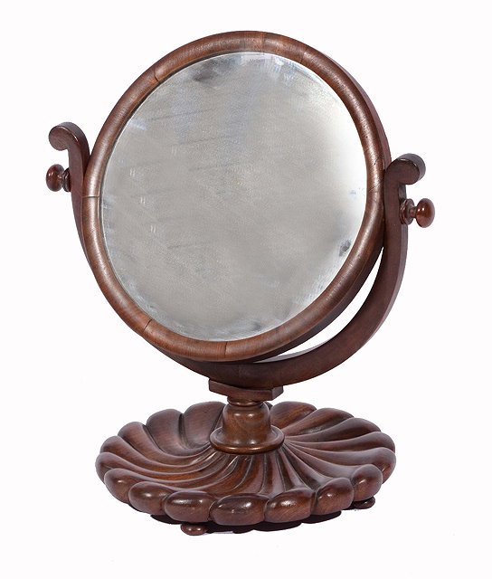 Appraisal: A VICTORIAN MAHOGANY CIRCULAR SHAVING MIRROR adjustable and on scallop