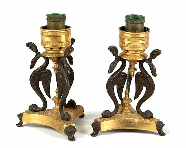 Appraisal: A pair of Empire style gilt and patinated bronze candlesticks