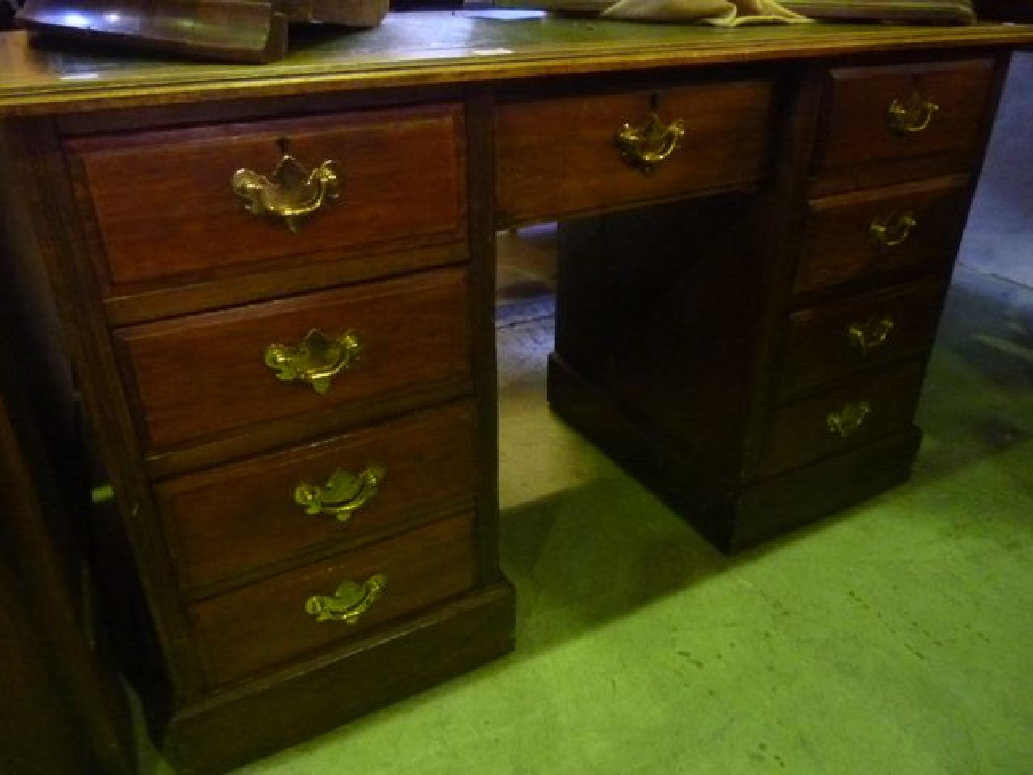 Appraisal: An Edwardian stained mixed wood kneehole twin pedestal desk of