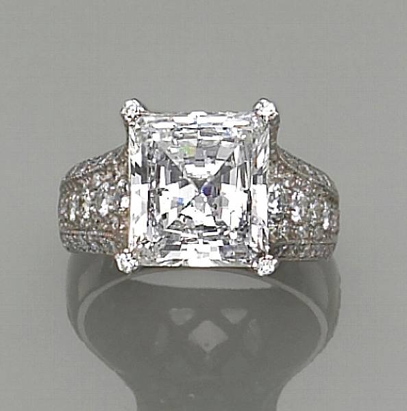 Appraisal: centering a rectangular-shaped step-cut diamond weighing carats accented on the