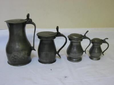 Appraisal: A PEWTER JUG of slender baluster form the hinged flat