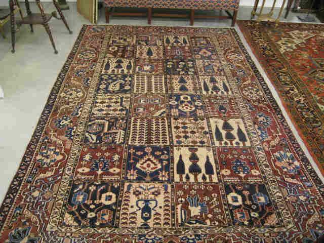 Appraisal: Baktaira Persian Handmade Rug panel style stylized florals reds blues