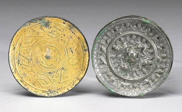 Appraisal: Two cast bronze mirrors The first a thinly sectioned Han