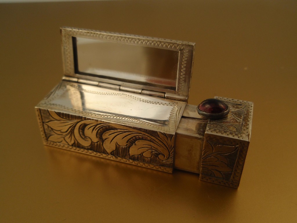 Appraisal: An Italian silver lipstick compact with integral mirror and cabachon