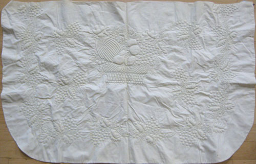 Appraisal: White trapunto work dresser scarf th c with central basket