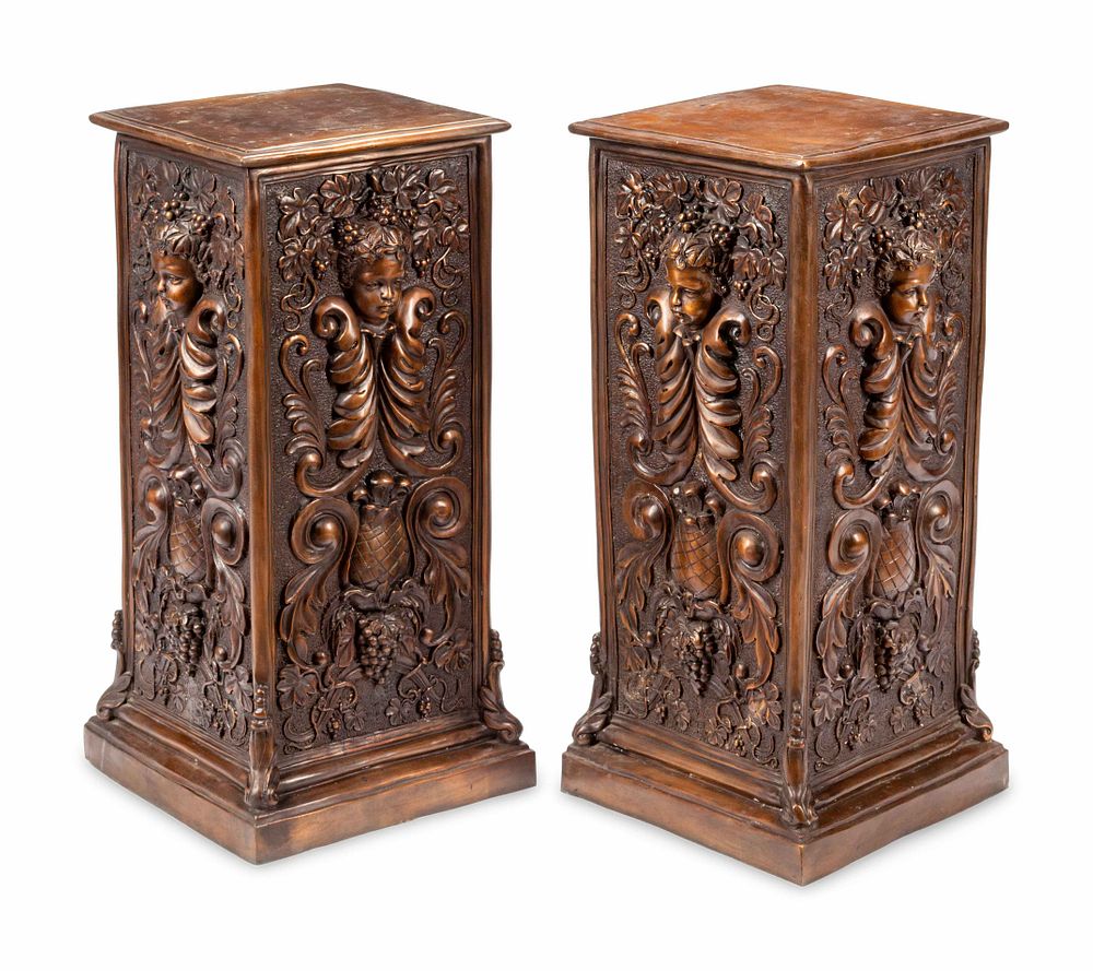 Appraisal: A Pair of Continental Patinated Bronze Pedestals with Cherub Masks