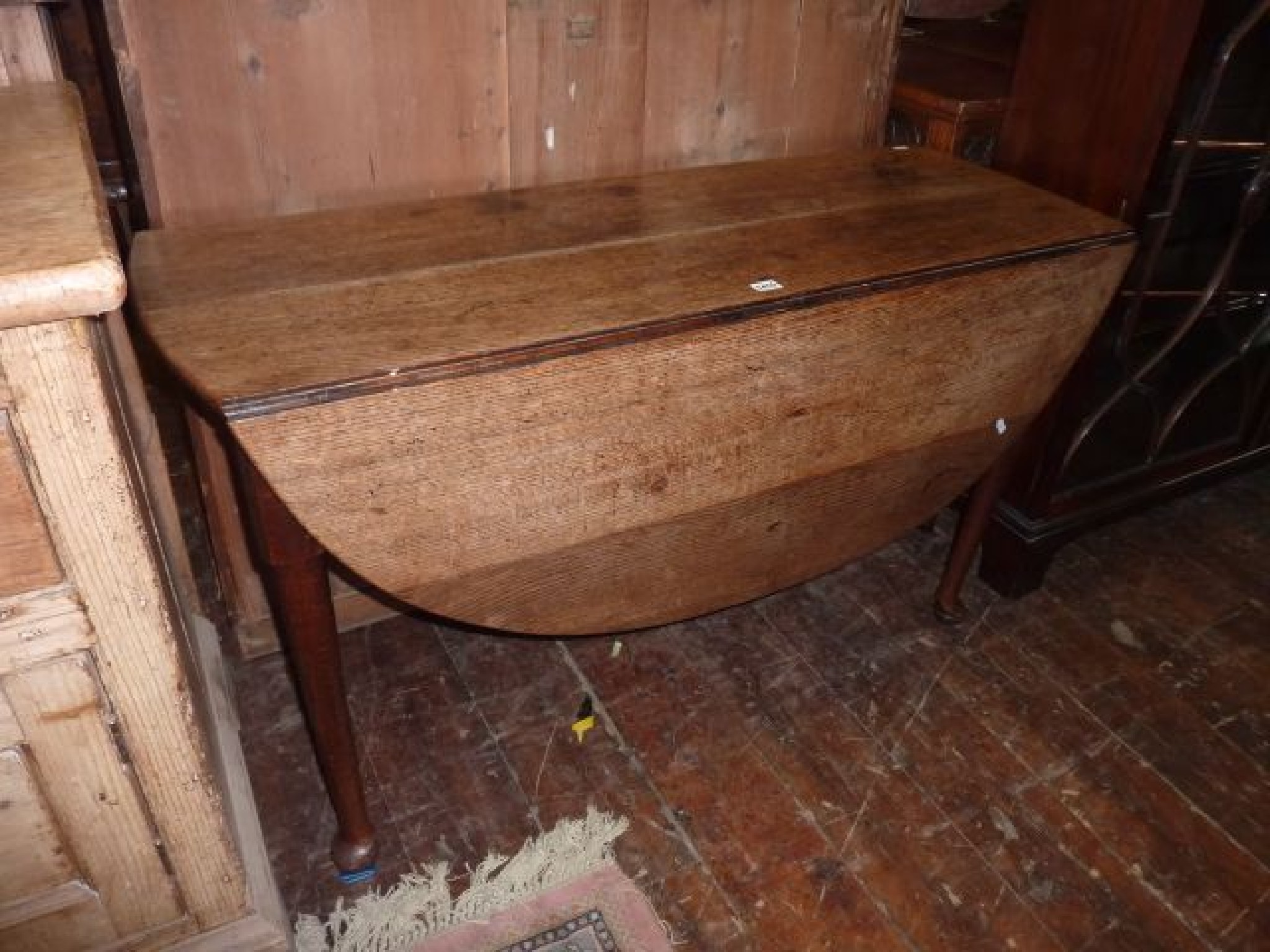 Appraisal: A Georgian oak dropleaf dining table raised on four pad