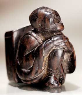 Appraisal: ANTIQUE WOOD NETSUKE Antique carved wood netsuke of a seated