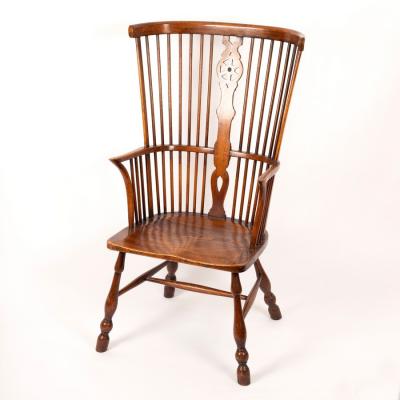 Appraisal: A Windsor type comb back chair with elm seat on