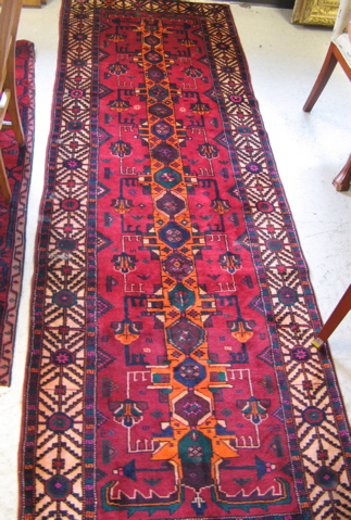 Appraisal: PERSIAN BELOUCH RUNNER geometric and stylized floral design on red