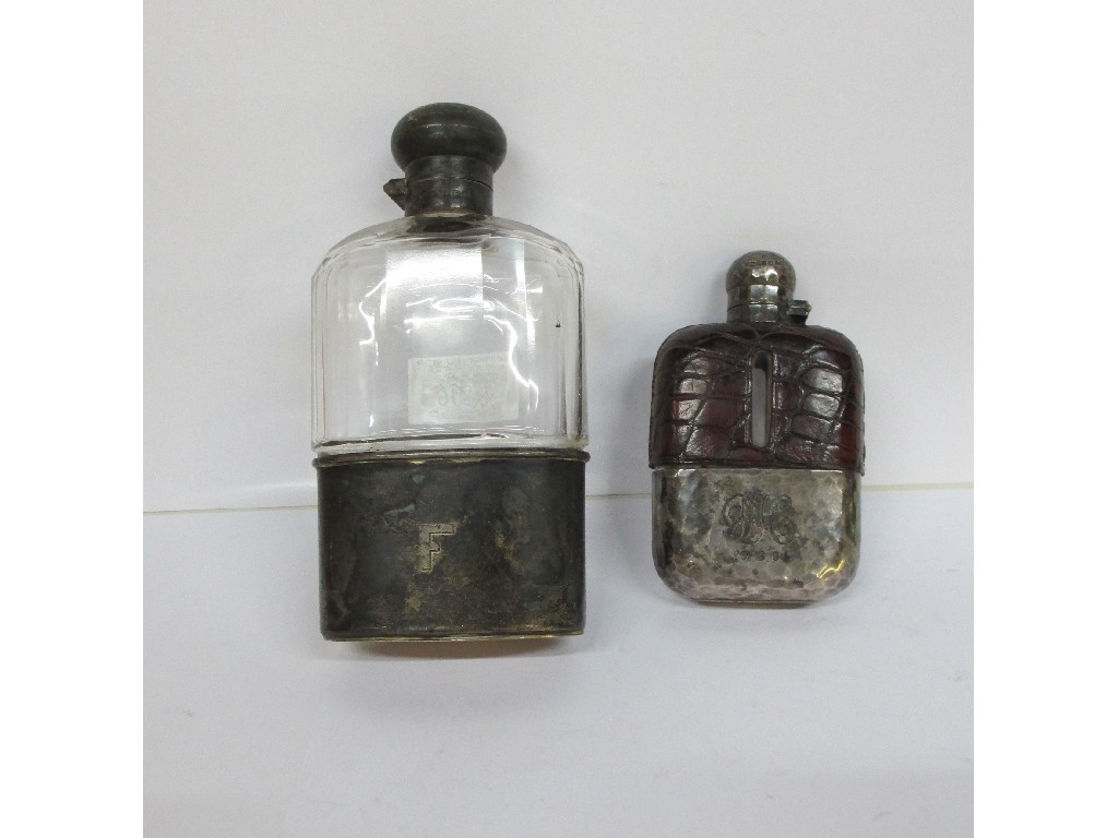 Appraisal: A lot comprising two silver mounted spirit flasks Sheffield and