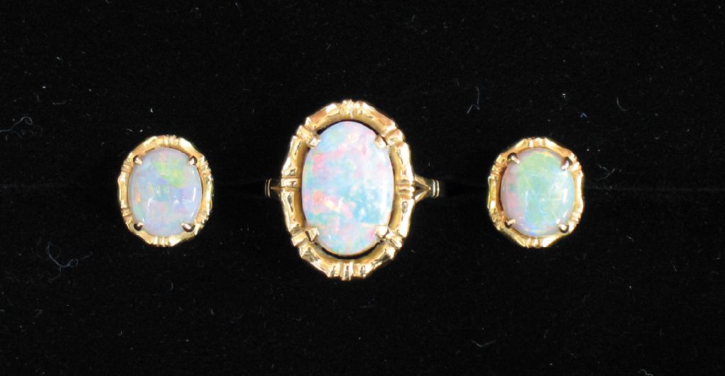 Appraisal: A MODERN OPAL DRESS RING the central oval opal claw-set