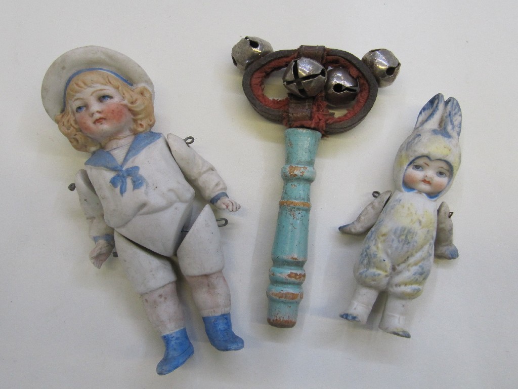 Appraisal: Lot comprising two miniature dolls and a baby rattle