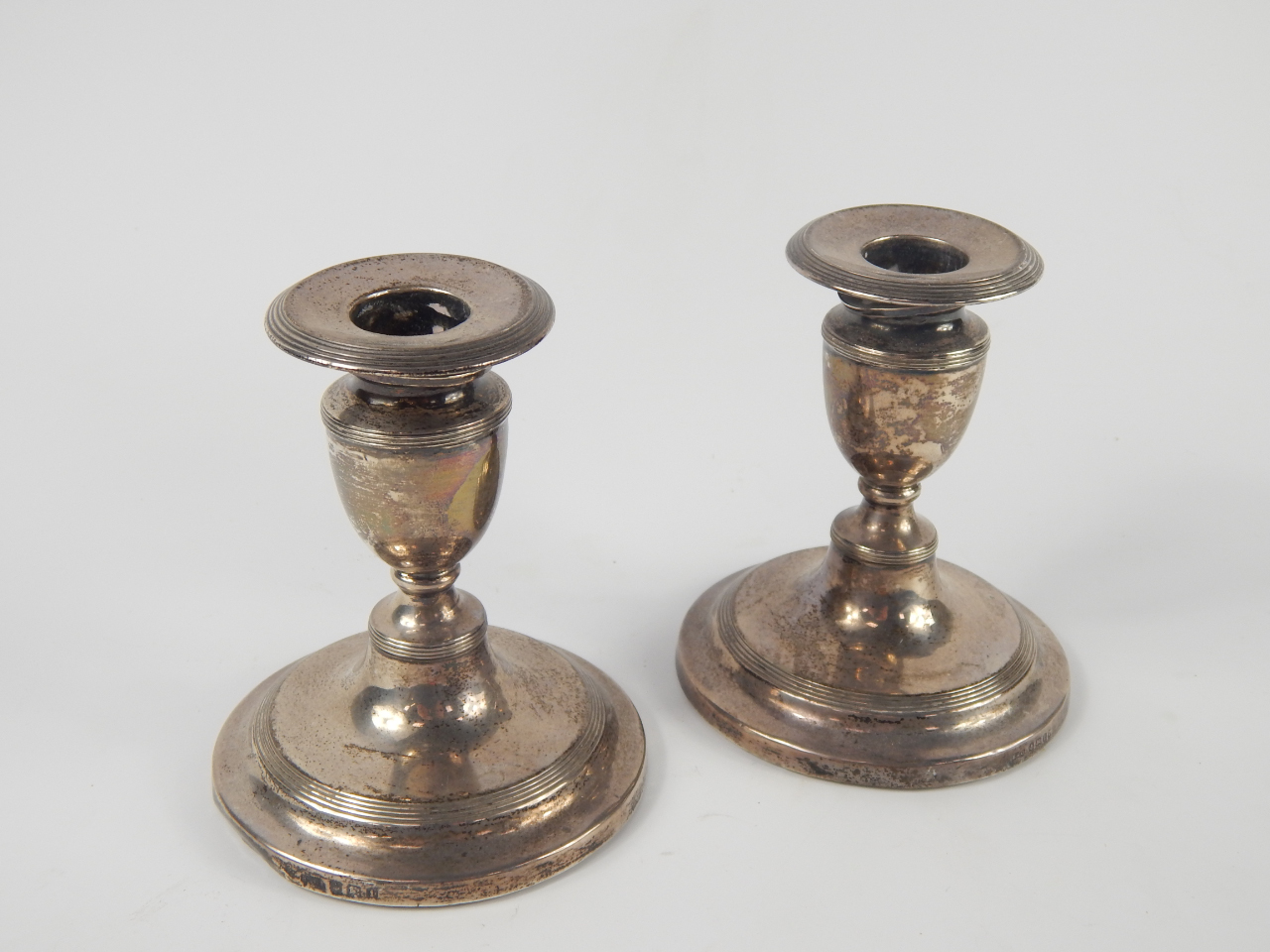 Appraisal: A pair of Edward VIII loaded silver candlesticks of turned