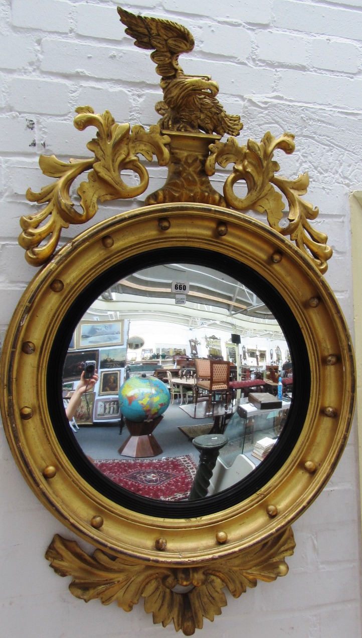 Appraisal: A Regency gilt framed convex circular wall mirror with eagle