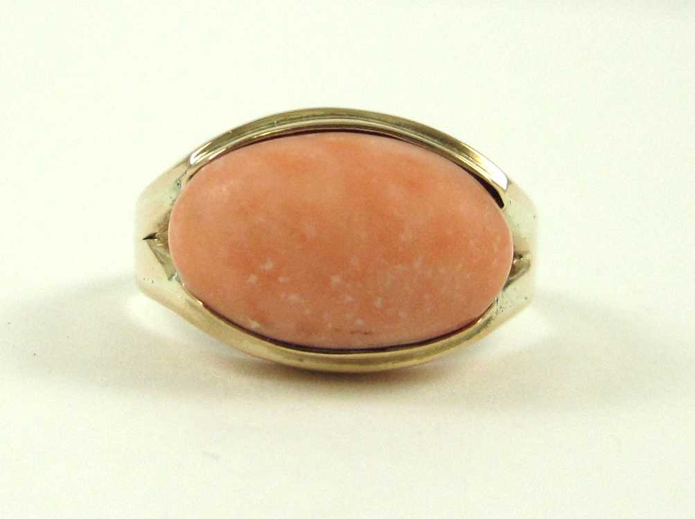 Appraisal: PINK CORAL AND FOURTEEN KARAT GOLD RING The solitaire ring