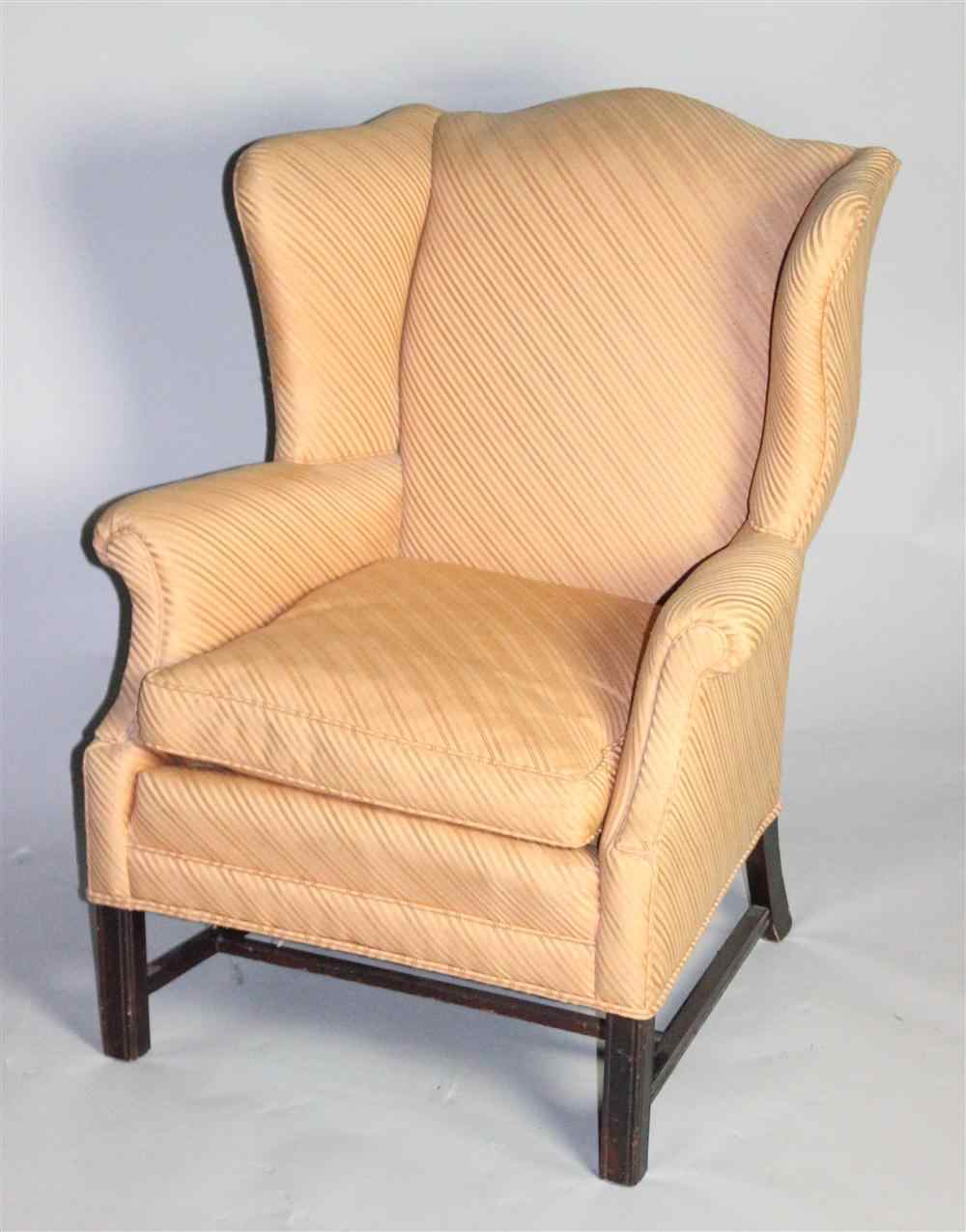 Appraisal: CHIPPENDALE STYLE UPHOLSTERED WING CHAIR having an arched crest rail