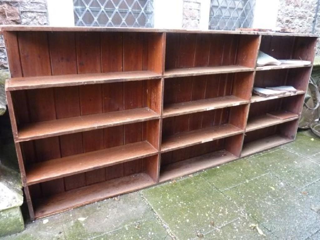 Appraisal: A substantial pitch pine two sectional wall mounted bookcase in