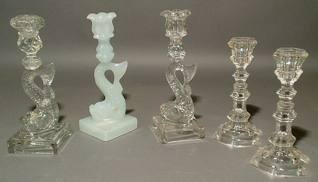 Appraisal: Two Sandwich glass candlesticks h two glass dolphin-form candlesticks h