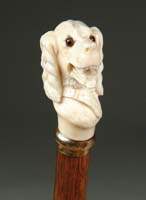 Appraisal: CARVED IVORY DOG HEAD CANE Finely modeled and carved Spaniel