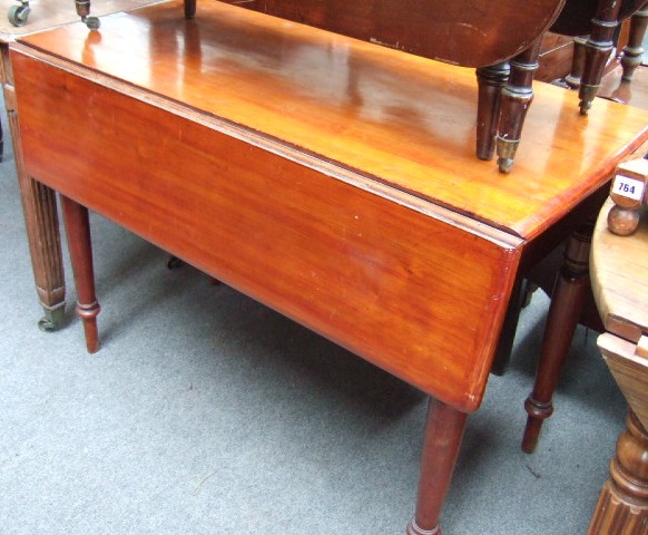 Appraisal: A Victorian fruitwood drop flap table with single frieze drawer