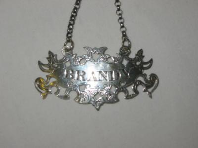 Appraisal: A VICTORIAN DECANTER LABEL inscribed Brandy within pierced foliate border