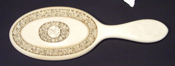 Appraisal: Victorian ivory backed hand mirror finely carved with bands of