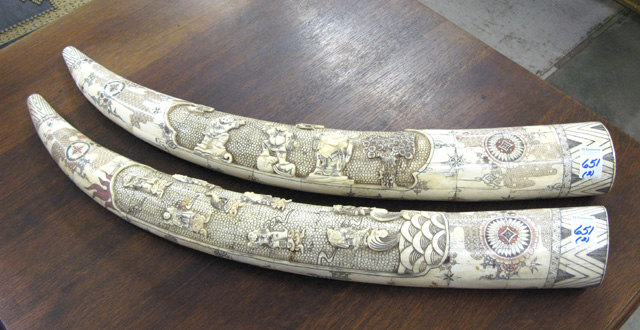 Appraisal: PAIR BONE CARVED TUSKS scrimshawed and polychromed having numerous figures