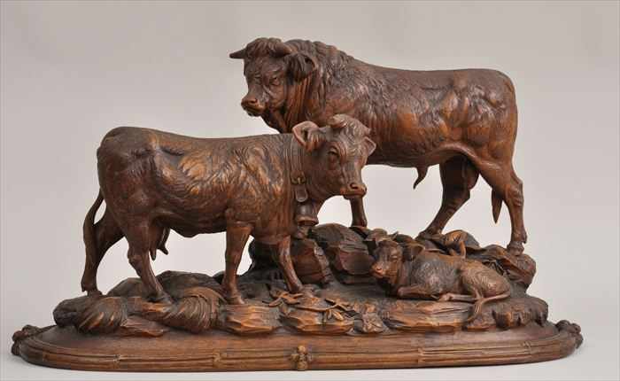 Appraisal: BLACK FOREST CARVED WALNUT BOVINE GROUP Incorporating a bull cow