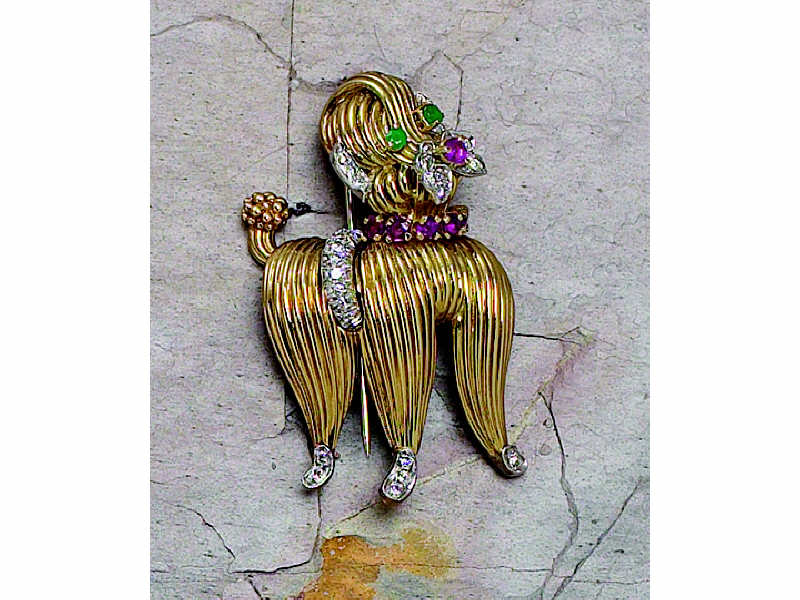 Appraisal: POODLE BROOCH k yellow gold with rubies emeralds and diamonds