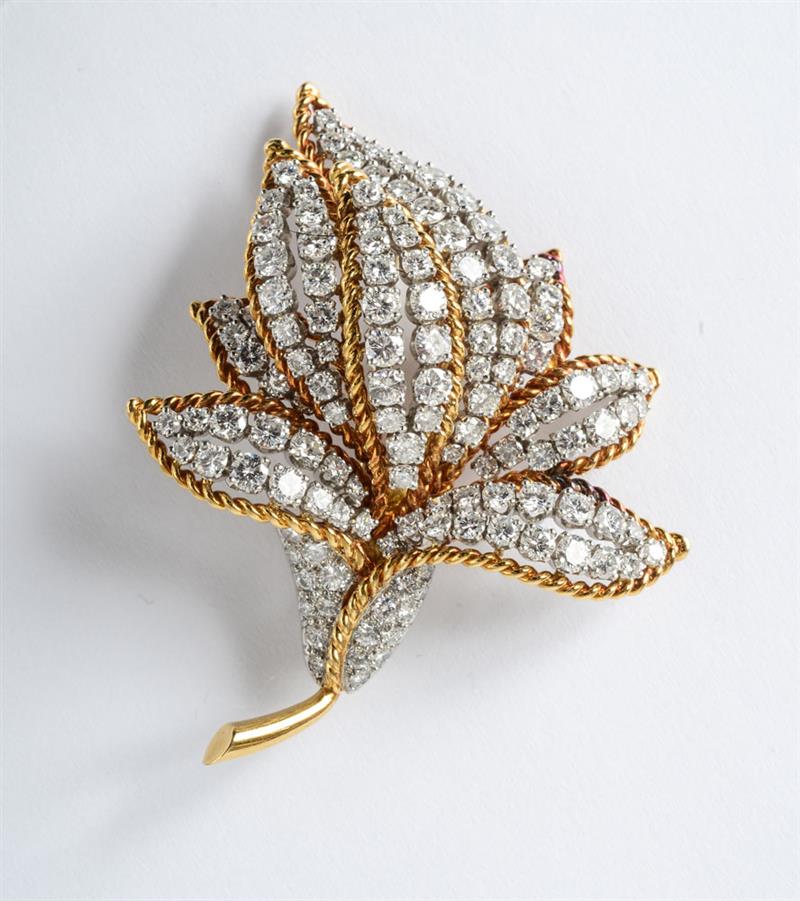 Appraisal: K GOLD AND DIAMOND FLORAL BROOCH Yellow and white gold