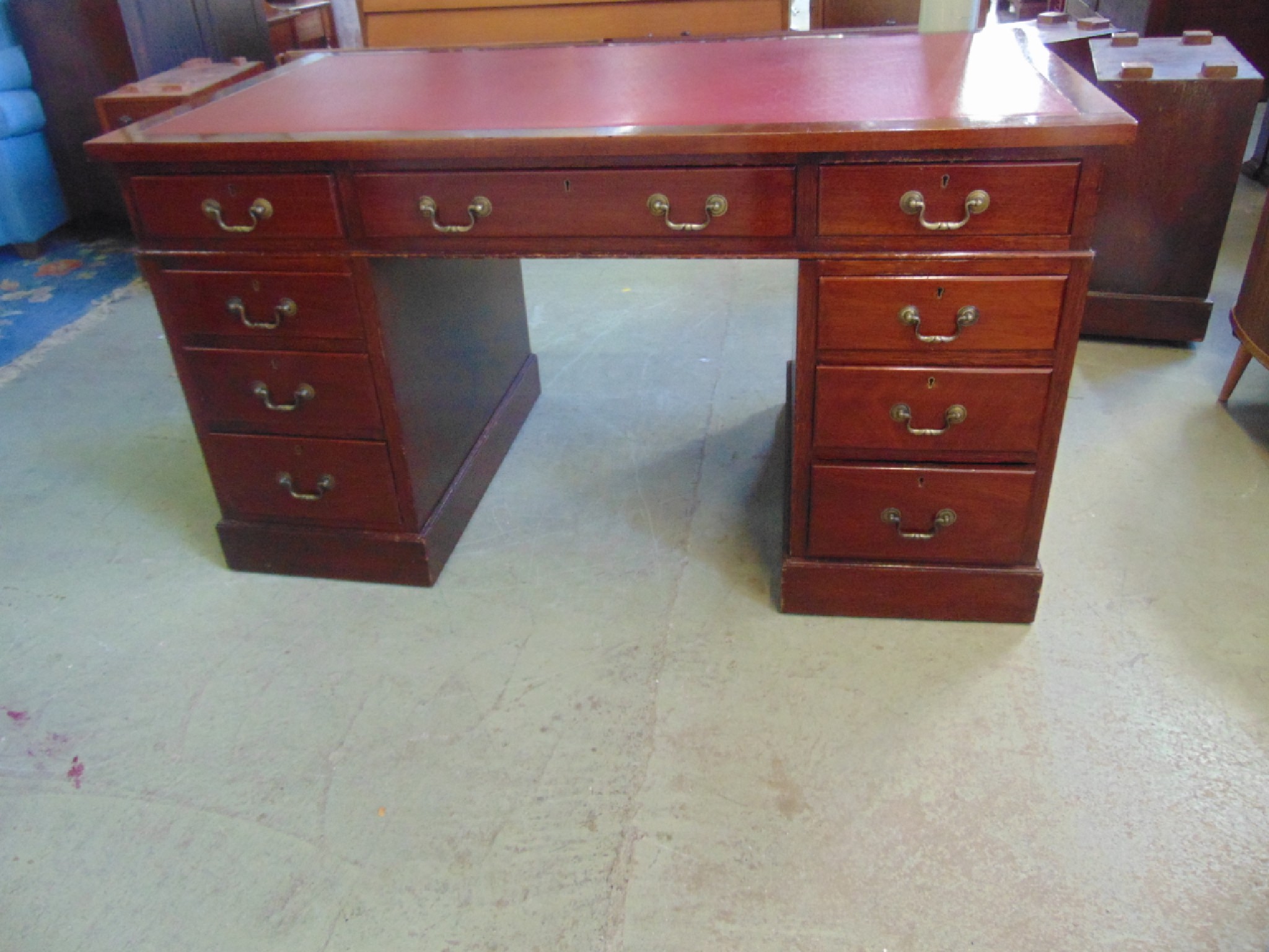 Appraisal: A vintage mahogany kneehole twin pedestal writing desk in the