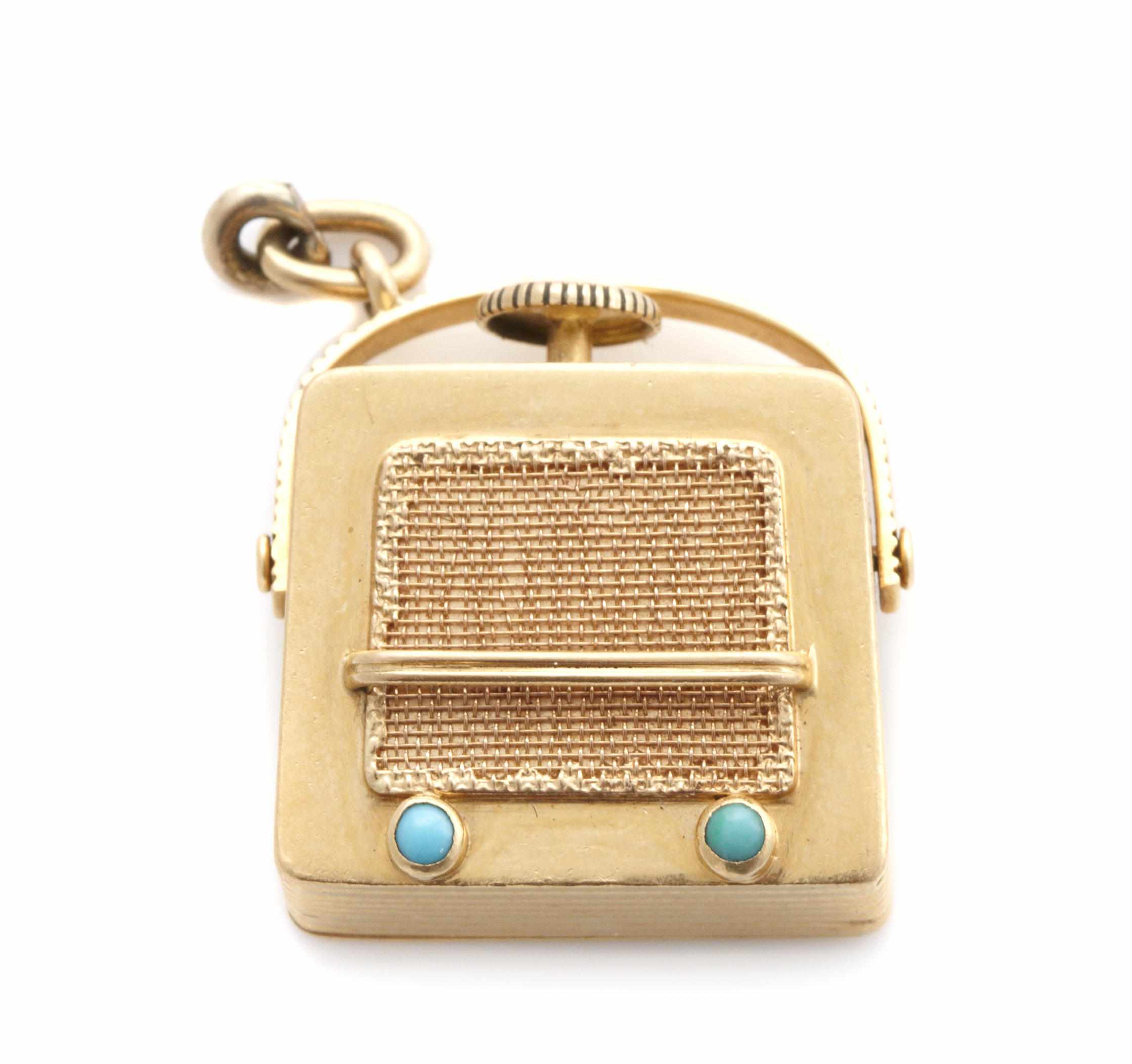 Appraisal: An k gold and turquoise ''radio motif'' music charm with