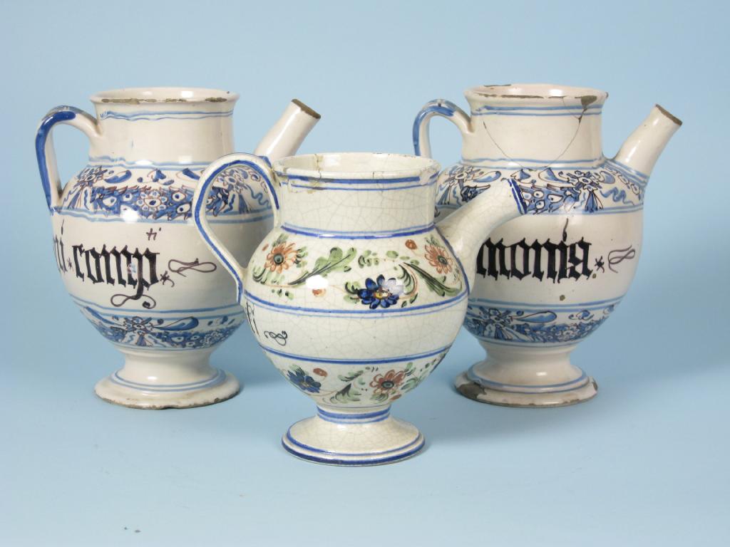 Appraisal: A pair of Delft Jugs with loop handles decorated flowers