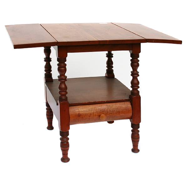 Appraisal: An American fruitwood drop leaf work table height in overall