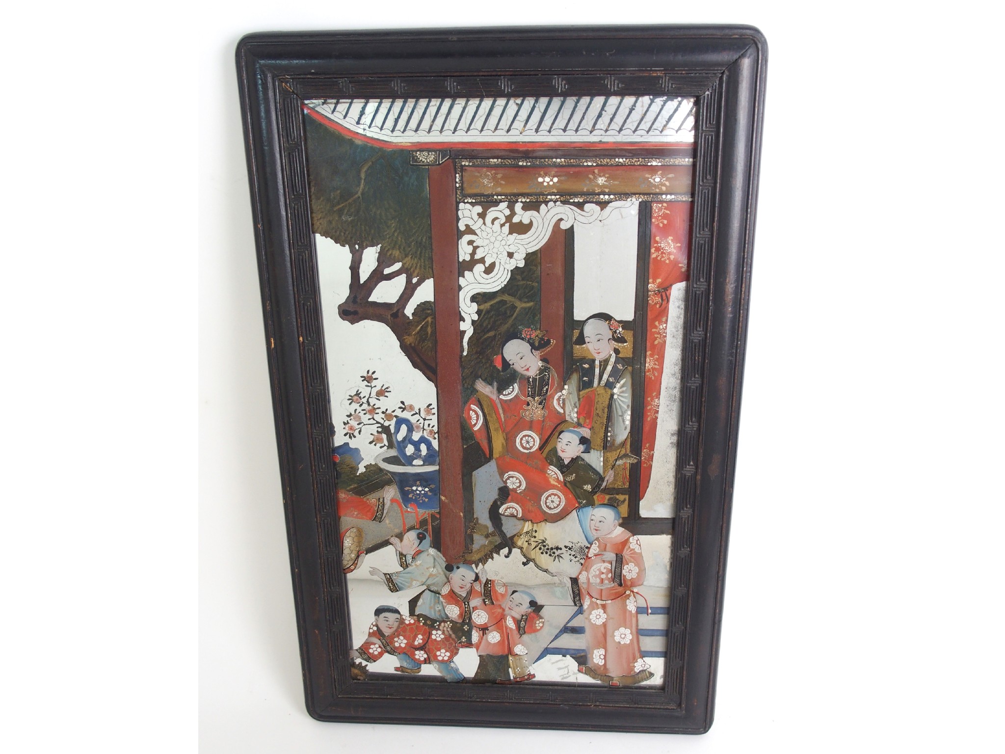 Appraisal: A Chinese reverse painted mirrordecorated with a family group in