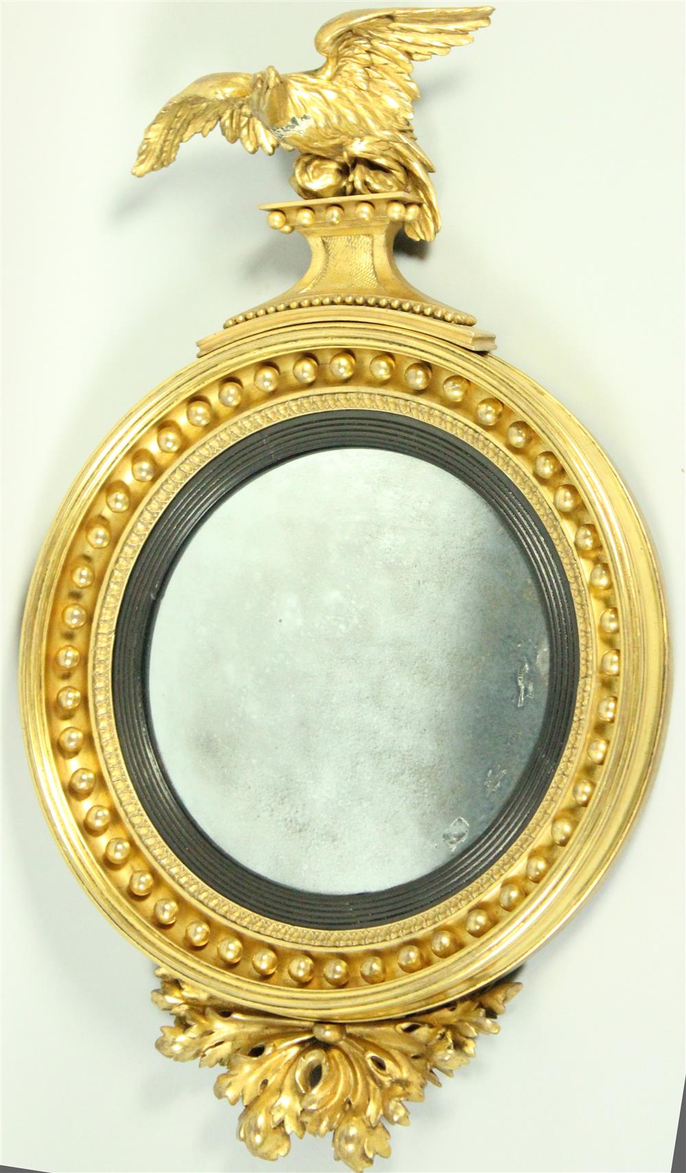 Appraisal: REGENCY GILTWOOD BULLSEYE MIRROR WITH EAGLE CREST AND FOLIATE DECORATION