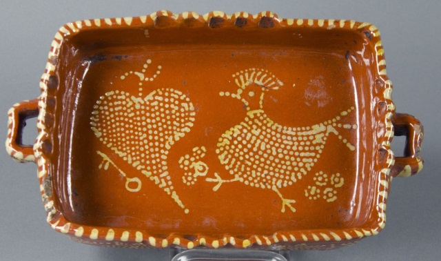 Appraisal: Redware Dish with Open HandlesHaving heart and chicken motif in