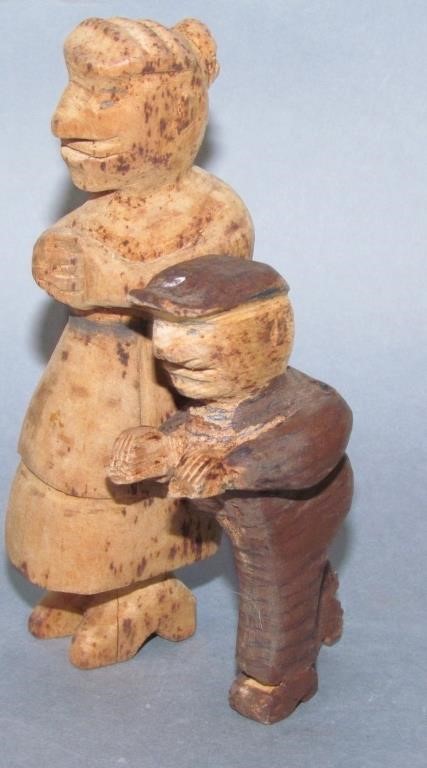 Appraisal: FIGURAL CARVINGSa woman worn a smaller man carving worn