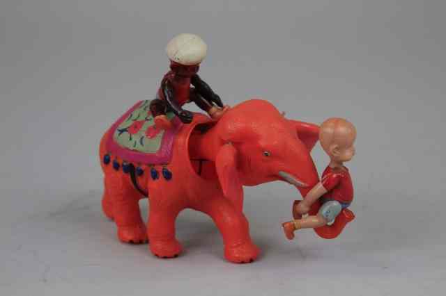 Appraisal: HENRY AND THE MAHOUT ON ELEPHANT Celluloid toy orange elephant