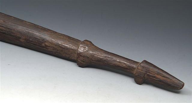 Appraisal: A TRIBAL WOODEN IMPLEMENT long and two ebonised walking sticks